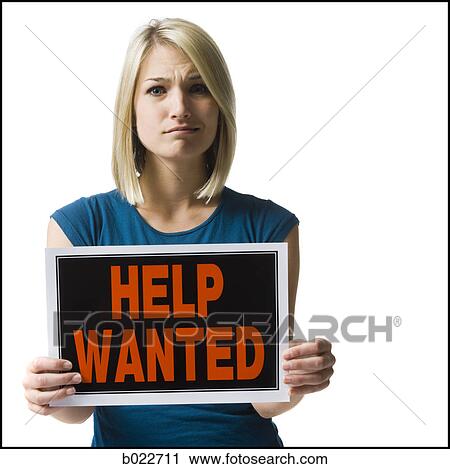 Stock Image - woman holding a help wanted sign. Fotosearch