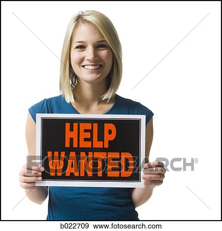 Stock Photo - woman holding a help wanted sign. Fotosearch