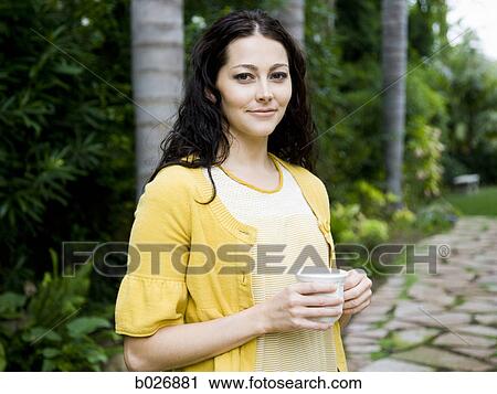 Stock Image - woman holding a mug. Fotosearch