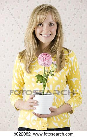 woman holding a potted flower View Large Photo Image Stock Image - woman holding a potted flower. Fotosearch