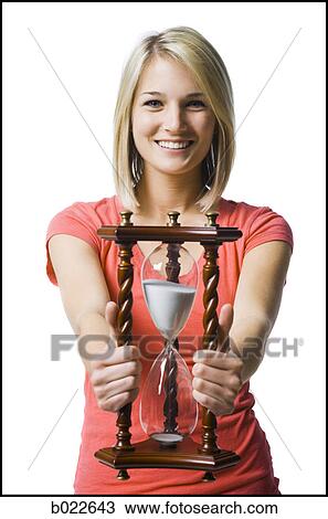 woman holding an hourglass View Large Photo Image Stock Image - woman holding an hourglass. Fotosearch