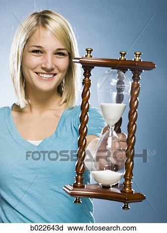 woman holding an hourglass View Large Photo Image Stock Image - woman holding an hourglass. Fotosearch