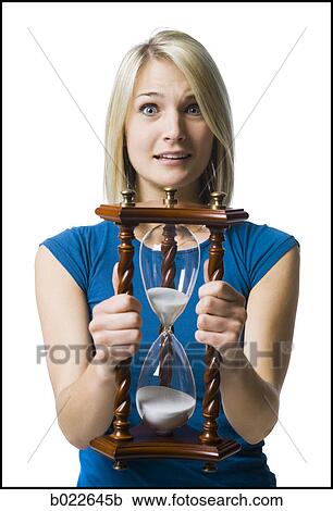 woman holding an hourglass View Large Photo Image Stock Image - woman holding an hourglass. Fotosearch