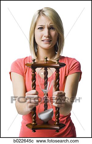 woman holding an hourglass View Large Photo Image Stock Image - woman holding an hourglass. Fotosearch
