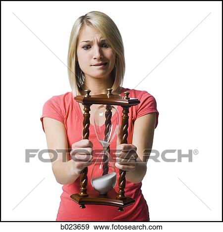 woman holding an hourglass View Large Photo Image Stock Photo - woman holding an hourglass. Fotosearch