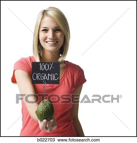 woman holding an organic avocado View Large Photo Image Stock Image - woman holding an organic avocado. Fotosearch