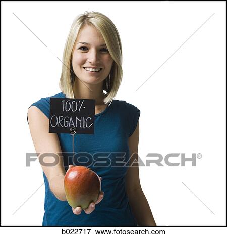 woman holding an organic mango View Large Photo Image Stock Photo - woman holding an organic mango. Fotosearch