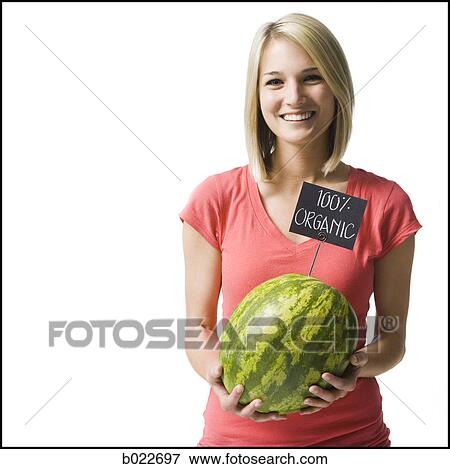 Stock Photo - woman holding an organic watermelon. Fotosearch