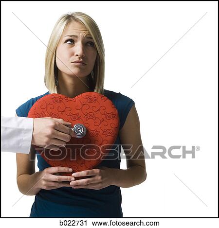 woman holding an oversized red heart View Large Photo Image Stock Image - woman holding an oversized red heart. Fotosearch