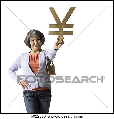 Stock Image - woman holding currency symbol. Fotosearch