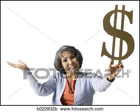 Stock Image - woman holding currency symbol. Fotosearch