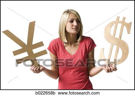 Stock Image - woman holding currency symbols. Fotosearch