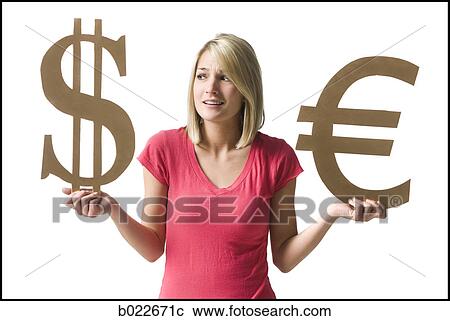 Stock Image - woman holding currency symbols. Fotosearch