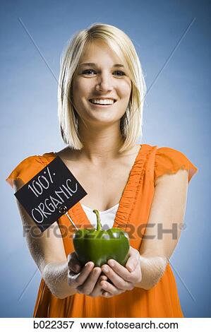 Stock Photo - woman holding organic produce. Fotosearch