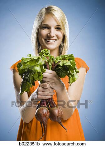 woman holding radishes View Large Photo Image Stock Image - woman holding radishes. Fotosearch