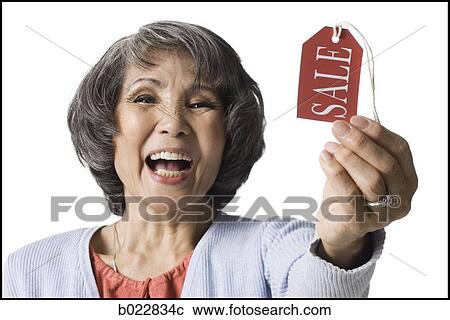 woman holding "sale" tag View Large Photo Image Stock Image - woman holding "sale" tag. Fotosearch