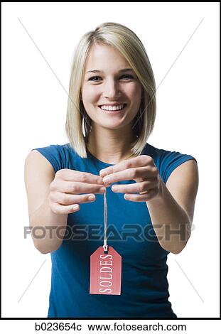 Stock Image - woman holding sale tag. Fotosearch