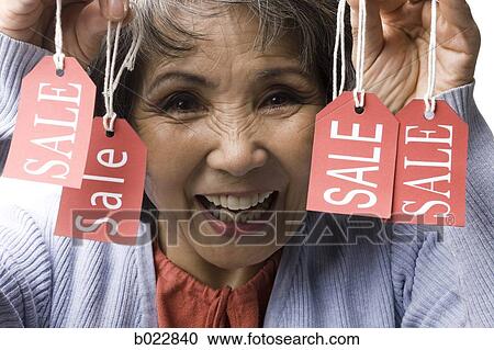 woman holding "sale" tags View Large Photo Image Stock Image - woman holding "sale" tags. Fotosearch