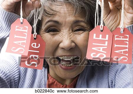 woman holding "sale" tags View Large Photo Image Stock Image - woman holding "sale" tags. Fotosearch