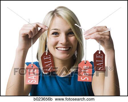 Stock Image - woman holding sale tags. Fotosearch