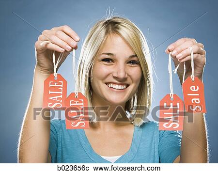 woman holding sale tags View Large Photo Image Stock Image - woman holding sale tags. Fotosearch