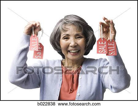 Stock Photo - woman holding "sale" tags. Fotosearch