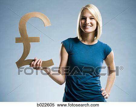 woman holding up a british pound symbol View Large Photo Image Stock Photography - woman holding up a british pound symbol. Fotosearch