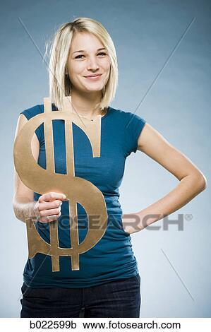 woman holding up a dollar symbol View Large Photo Image Stock Image - woman holding up a dollar symbol. Fotosearch