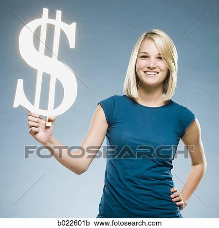 woman holding up a dollar symbol View Large Photo Image Stock Image - woman holding up a dollar symbol. Fotosearch