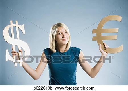 woman holding up currency symbols View Large Photo Image Stock Image - woman holding up currency symbols. Fotosearch