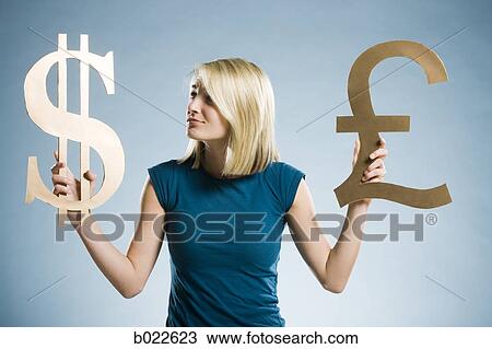 woman holding up currency symbols View Large Photo Image Stock Image - woman holding up currency symbols. Fotosearch