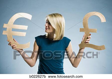woman holding up currency symbols View Large Photo Image Stock Image - woman holding up currency symbols. Fotosearch