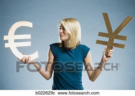 woman holding up currency symbols View Large Photo Image Stock Image - woman holding up currency symbols. Fotosearch