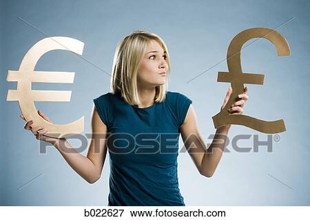 woman holding up currency symbols View Large Photo Image Stock Photo - woman holding up currency symbols. Fotosearch