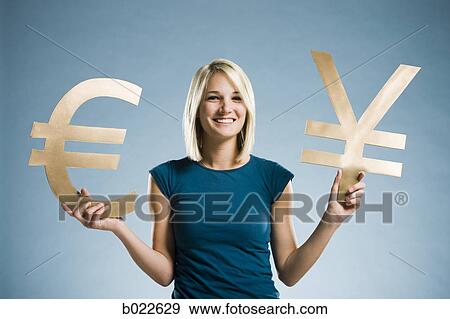 woman holding up currency symbols View Large Photo Image Stock Photo - woman holding up currency symbols. Fotosearch