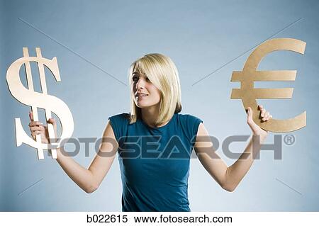 woman holding up currency symbols View Large Photo Image Stock Photography - woman holding up currency symbols. Fotosearch