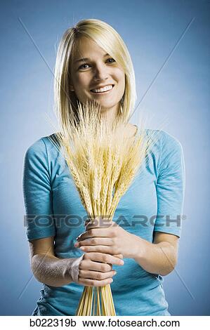 woman holding up wheat View Large Photo Image Stock Image - woman holding up wheat. Fotosearch