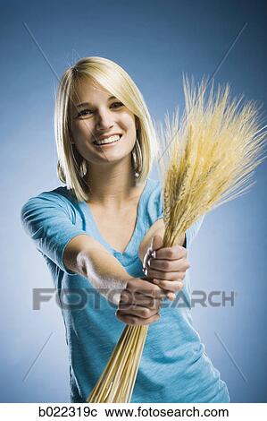 woman holding up wheat View Large Photo Image Stock Image - woman holding up wheat. Fotosearch