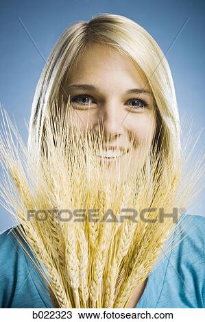 woman holding up wheat View Large Photo Image Stock Image - woman holding up wheat. Fotosearch