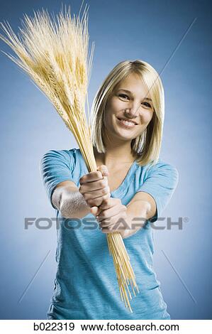 woman holding up wheat View Large Photo Image Stock Photo - woman holding up wheat. Fotosearch
