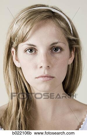 Stock Image - woman in a blue dress with a straight face. Fotosearch