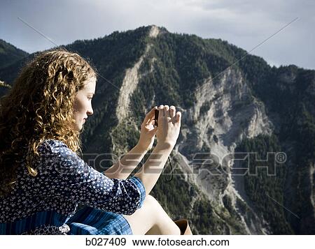 woman in a floral print dress on a mountain top View Large Photo Image Stock Photo - woman in a floral print dress on a mountain top. Fotosearch