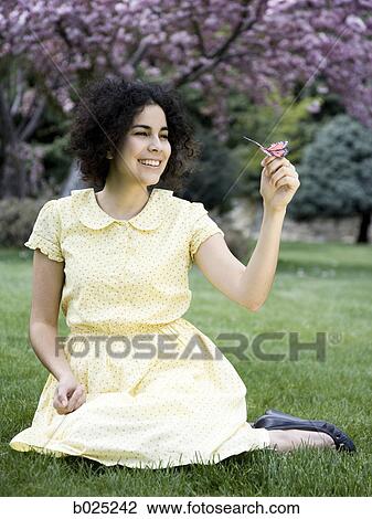 woman in a yellow dress holding a butterfly View Large Photo Image Stock Image - woman in a yellow dress holding a butterfly. Fotosearch