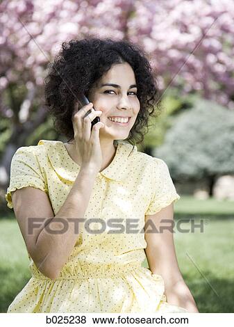 woman in a yellow dress on the phone View Large Photo Image Stock Photo - woman in a yellow dress on the phone. Fotosearch