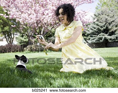 woman in a yellow dress taking photos View Large Photo Image Stock Image - woman in a yellow dress taking photos. Fotosearch