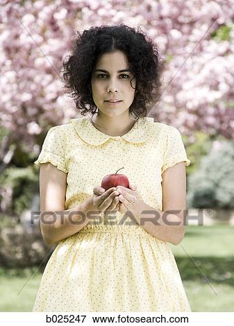 woman in a yellow dress with a red apple View Large Photo Image Stock Photo - woman in a yellow dress with a red apple. Fotosearch