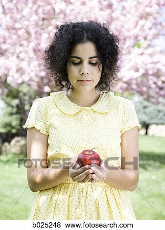 woman in a yellow dress with a red apple View Large Photo Image Stock Photo - woman in a yellow dress with a red apple. Fotosearch