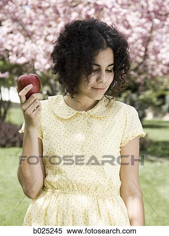 woman in a yellow dress with a red apple View Large Photo Image Stock Photography - woman in a yellow dress with a red apple. Fotosearch