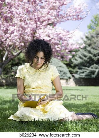 woman in a yellow dress with her diary View Large Photo Image Picture - woman in a yellow dress with her diary. Fotosearch