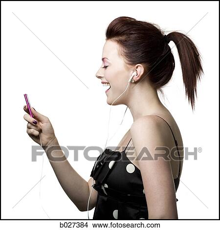 woman listening to digital music on her ipod View Large Photo Image Picture - woman listening to digital music on her ipod. Fotosearch